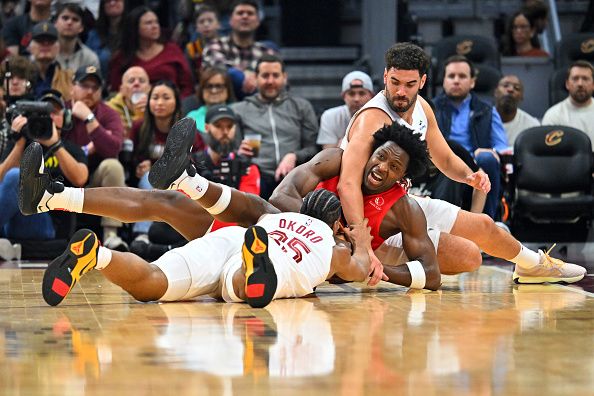 CLEVELAND, OHIO - NOVEMBER 26: O.G. Anunoby #3 of the Toronto Raptors fights for a loose ball with Georges Niang #20 and Isaac Okoro #35 of the Cleveland Cavaliers during the second quarter at Rocket Mortgage Fieldhouse on November 26, 2023 in Cleveland, Ohio. NOTE TO USER: User expressly acknowledges and agrees that, by downloading and or using this photograph, User is consenting to the terms and conditions of the Getty Images License Agreement. (Photo by Jason Miller/Getty Images)