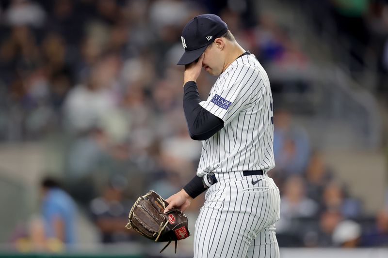 Aug 22, 2023; Bronx, New York, USA; New York Yankees relief pitcher Tommy Kahnle (41) reacts during the eighth inning against the Washington Nationals at Yankee Stadium. Mandatory Credit: Brad Penner-USA TODAY Sports