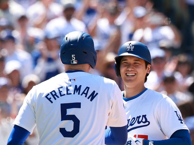 May 5, 2024; Los Angeles, California, USA;  Los Angeles Dodgers designated hitter Shohei Ohtani (17) is greeted by first base Freddie Freeman (5) after hitting a home run during the eighth inning against the Atlanta Braves at Dodger Stadium. Mandatory Credit: Kiyoshi Mio-USA TODAY Sports