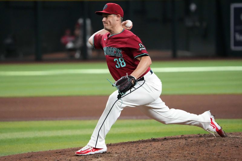 Jul 28, 2024; Phoenix, Arizona, USA; Arizona Diamondbacks pitcher Paul Sewald (38) pitches against the Pittsburgh Pirates during the ninth inning at Chase Field. Mandatory Credit: Joe Camporeale-USA TODAY Sports