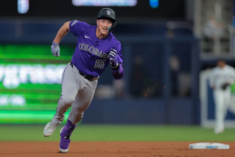 Jun 4, 2025; Miami, Florida, USA; Colorado Rockies catcher Hunter Goodman (15) rounds past second base after hitting an RBI triple against the Miami Marlins during the first inning at loanDepot Park. Mandatory Credit: Sam Navarro-Imagn Images