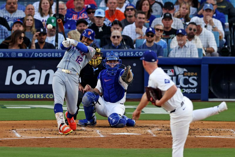 Oct 20, 2024; Los Angeles, California, USA; New York Mets shortstop Francisco Lindor (12) hits a single during the second inning against the Los Angeles Dodgers during game six of the NLCS for the 2024 MLB playoffs at Dodger Stadium. Mandatory Credit: Jason Parkhurst-Imagn Images