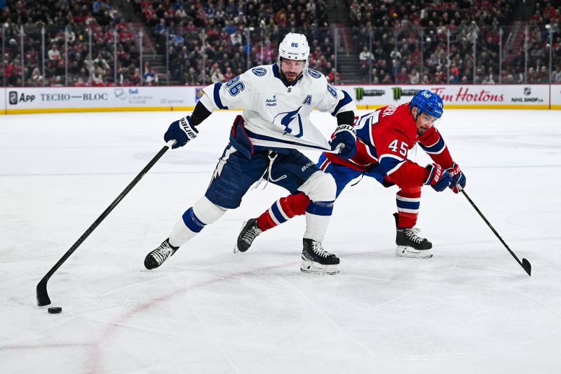 Jan 21, 2025; Montreal, Quebec, CAN; Tampa Bay Lightning right wing Nikita Kucherov (86) plays the puck against Montreal Canadiens defenseman Alexandre Carrier (45) during the second period at Bell Centre. Mandatory Credit: David Kirouac-Imagn Images
