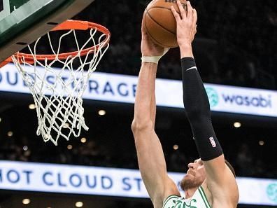 Boston, MA - December 17: Boston Celtics C Kristaps Porzingis dunks in the first quarter. The Celtics beat the Orlando Magic, 114-97. (Photo by Tanner Pearson/The Boston Globe via Getty Images)