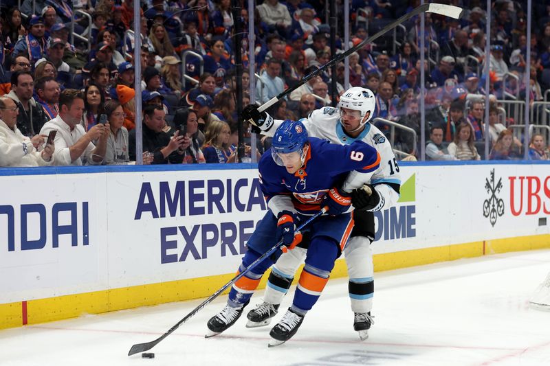 Oct 10, 2024; Elmont, New York, USA; New York Islanders defenseman Ryan Pulock (6) controls the puck against Utah Hockey Club center Alexander Kerfoot (15) during the third period at UBS Arena. Mandatory Credit: Brad Penner-Imagn Images