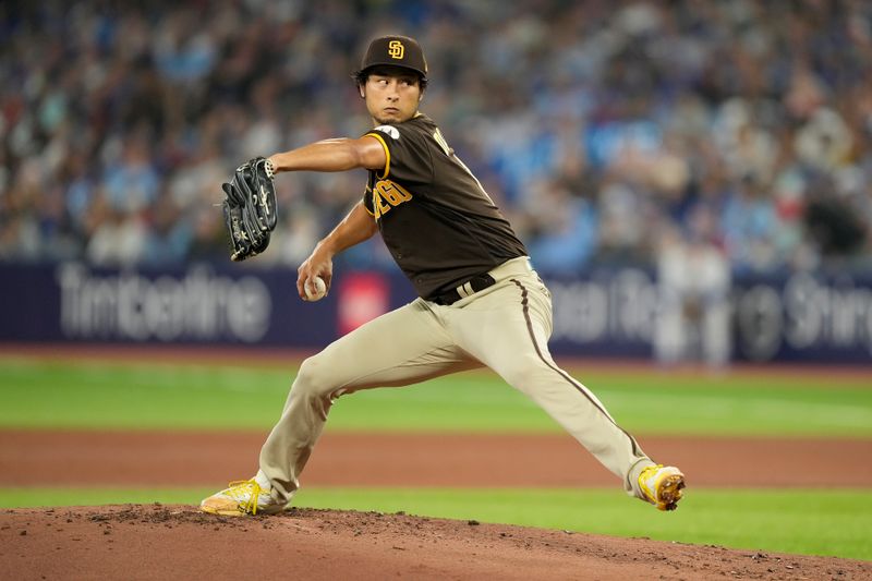 Jul 19, 2023; Toronto, Ontario, CAN; San Diego Padres starting pitcher Yu Darvish (11) pitches to the Toronto Blue Jays during the first inning at Rogers Centre. Mandatory Credit: John E. Sokolowski-USA TODAY Sports