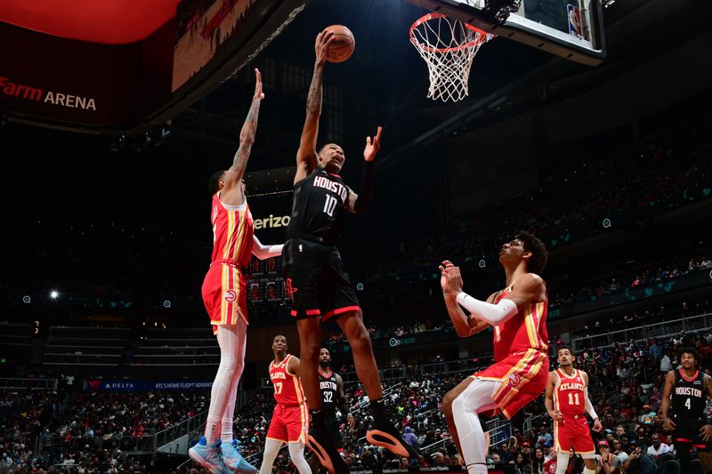 ATLANTA, GA - FEBRUARY 10: Jabari Smith Jr. #10 of the Houston Rockets grabs a rebound during the game against the Atlanta Hawks on February 10, 2024 at State Farm Arena in Atlanta, Georgia.  NOTE TO USER: User expressly acknowledges and agrees that, by downloading and/or using this Photograph, user is consenting to the terms and conditions of the Getty Images License Agreement. Mandatory Copyright Notice: Copyright 2024 NBAE (Photo by Scott Cunningham/NBAE via Getty Images)