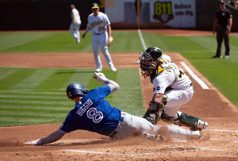 Sep 6, 2023; Oakland, California, USA; Toronto Blue Jays right fielder Cavan Biggio (8) scores a run against Oakland Athletics catcher Carlos P  rez (44) during the second inning at Oakland-Alameda County Coliseum. Mandatory Credit: D. Ross Cameron-USA TODAY Sports