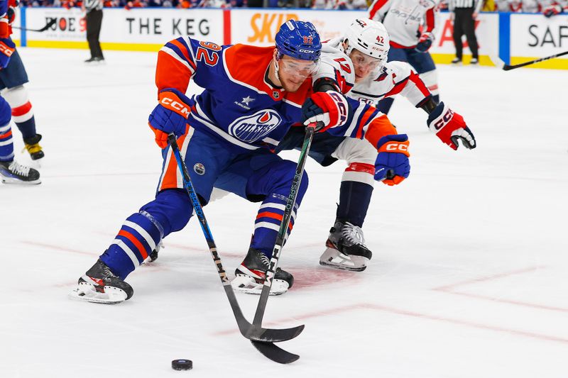 Jan 21, 2025; Edmonton, Alberta, CAN; Edmonton Oilers forward Vasily Podkolzin (92) protects the puck from Washington Capitals defensemen Martin Fehervary (42) during the third period at Rogers Place. Mandatory Credit: Perry Nelson-Imagn Images