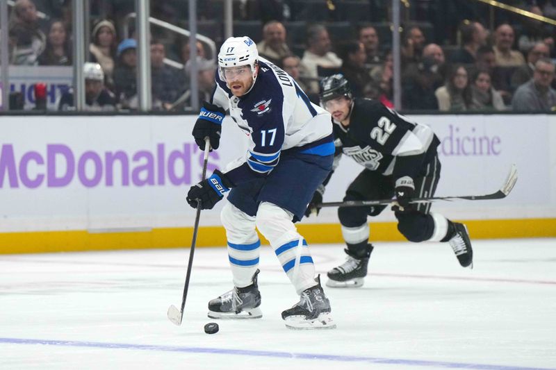 Nov 27, 2024; Los Angeles, California, USA; Winnipeg Jets center Adam Lowry (17) skates with the puck against the LA Kings in the third period at Crypto.com Arena. Mandatory Credit: Kirby Lee-Imagn Images