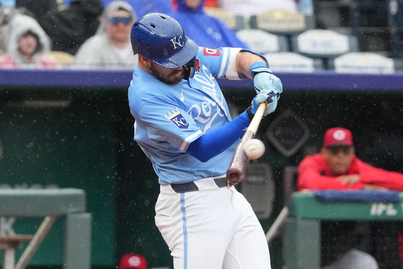 May 26, 2025; Kansas City, Missouri, USA; Kansas City Royals left fielder Nick Loftin (12) hits a one run sacrifice against the Cincinnati Reds in the seventh inning at Kauffman Stadium. Mandatory Credit: Denny Medley-Imagn Images