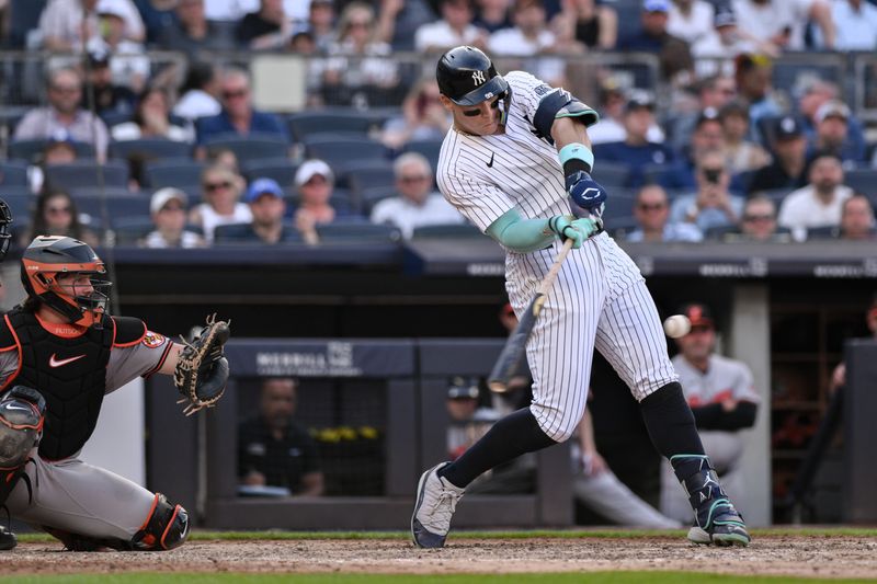 Jun 20, 2024; Bronx, New York, USA; New York Yankees outfielder Aaron Judge (99) hits a RBI single against the Baltimore Orioles during the fifth inning at Yankee Stadium. Mandatory Credit: John Jones-USA TODAY Sports