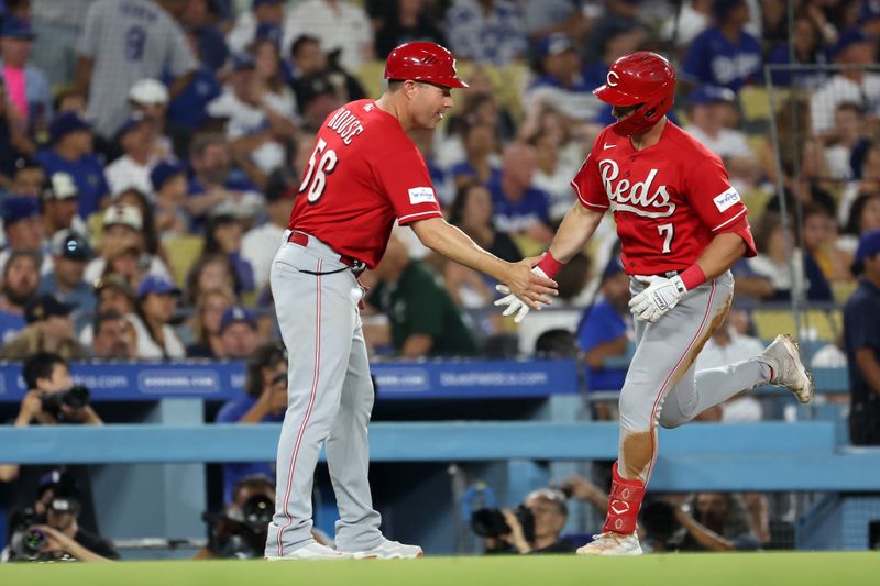 Jul 28, 2023; Los Angeles, California, USA;  Cincinnati Reds left fielder Spencer Steer (7) is greeted by third base coach JR House (56) after hitting a home run during the seventh inning against the Los Angeles Dodgers at Dodger Stadium. Mandatory Credit: Kiyoshi Mio-USA TODAY Sports