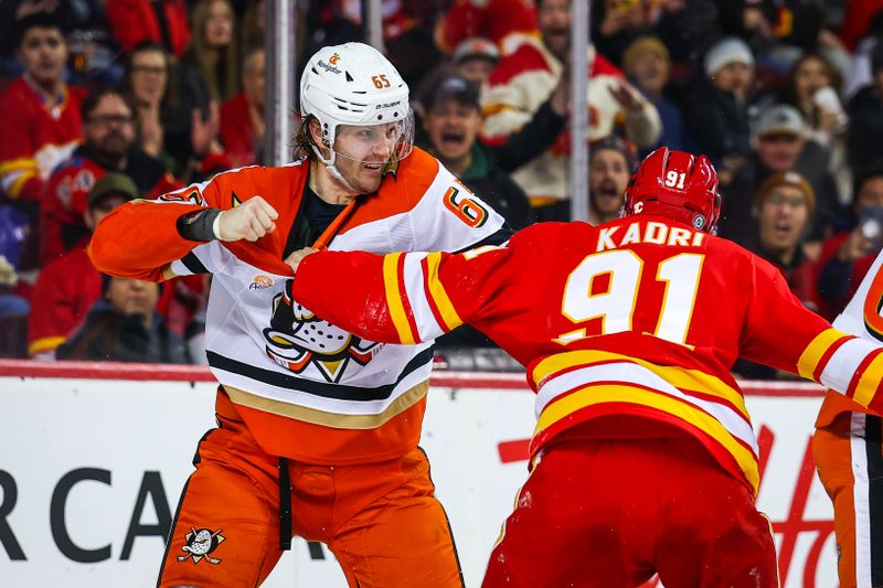 Jan 30, 2025; Calgary, Alberta, CAN; Anaheim Ducks defenseman Jacob Trouba (65) and Calgary Flames center Nazem Kadri (91) fights during the second period at Scotiabank Saddledome. Mandatory Credit: Sergei Belski-Imagn Images