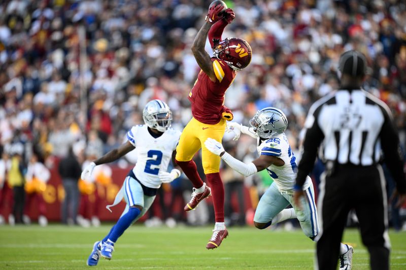 Washington Commanders wide receiver Dyami Brown (2) catches a pass as Dallas Cowboys cornerback DaRon Bland (26) defends during the second half of an NFL football game, Sunday, Nov. 24, 2024, in Landover, Md. (AP Photo/Nick Wass)