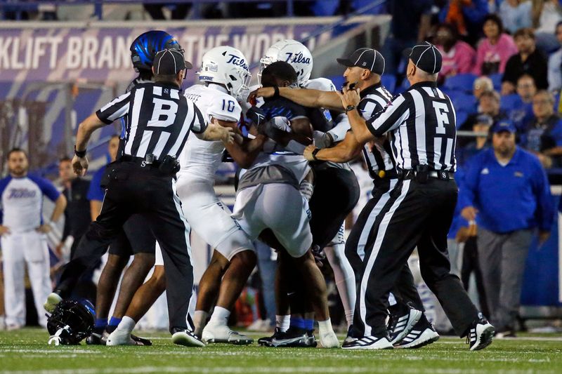 Nov 10, 2022; Memphis, Tennessee, USA; Referees break up a brawl between the Memphis Tigers and the Tulsa Golden Hurricane at Liberty Bowl Memorial Stadium. Mandatory Credit: Petre Thomas-USA TODAY Sports