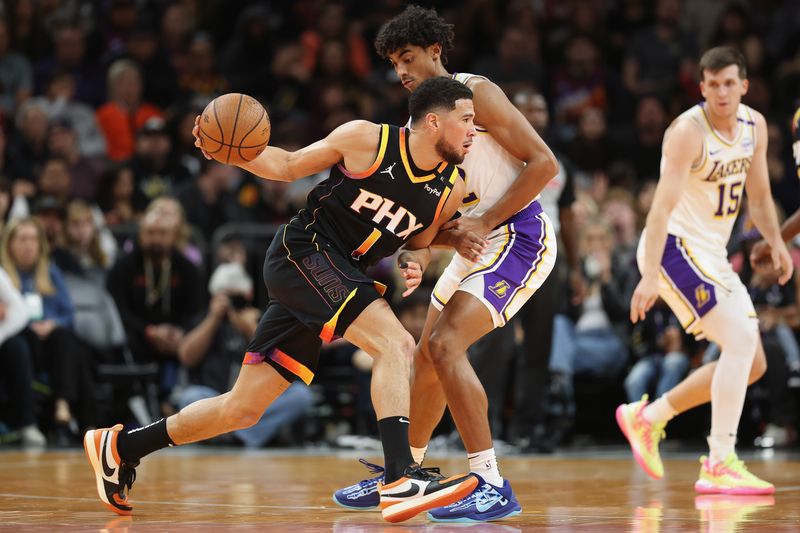 PHOENIX, ARIZONA - NOVEMBER 26: Devin Booker #1 of the Phoenix Suns drives the ball against Max Christie #12 of the Los Angeles Lakersduring the first half of the Emirates NBA Cup game at Footprint Center on November 26, 2024 in Phoenix, Arizona. NOTE TO USER: User expressly acknowledges and agrees that, by downloading and/or using this photograph, user is consenting to the terms and conditions of the Getty Images License Agreement. (Photo by Christian Petersen/Getty Images)