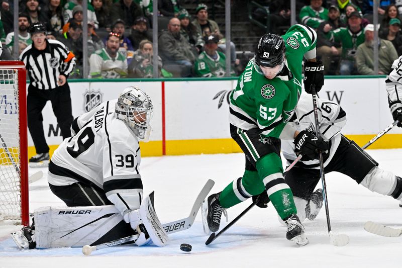 Jan 16, 2024; Dallas, Texas, USA; Los Angeles Kings goaltender Cam Talbot (39) stops a backhand shot by Dallas Stars center Wyatt Johnston (53) during the second period at the American Airlines Center. Mandatory Credit: Jerome Miron-USA TODAY Sports