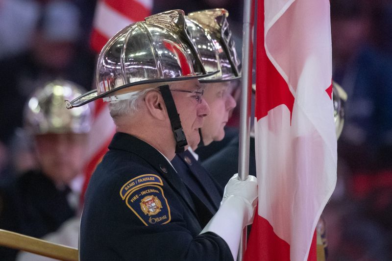 Dec 12, 2023; Ottawa, Ontario, CAN; The Ottawa Fire Service band play the National Anthems prior to the start of game between the Carolina Hurricanes and the Ottawa Senators at the Canadian Tire Centre. Mandatory Credit: Marc DesRosiers-USA TODAY Sports