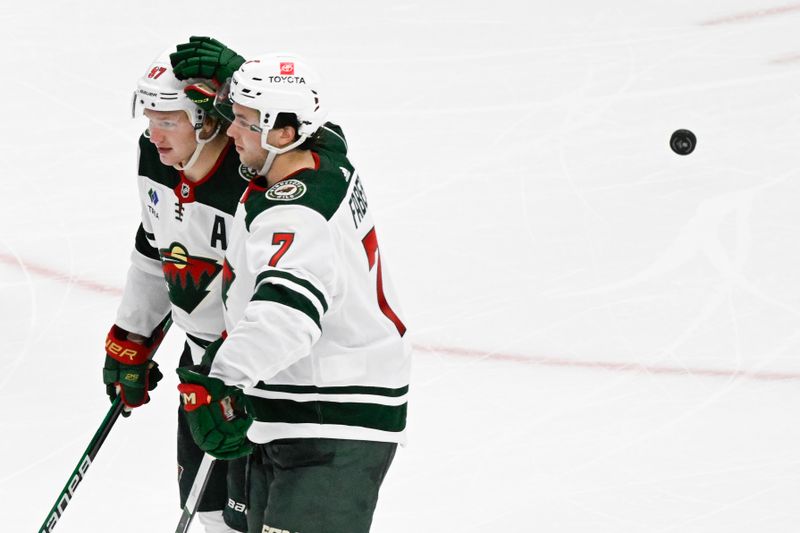 Apr 7, 2024; Chicago, Illinois, USA;  Minnesota Wild left wing Kirill Kaprizov (97), left, and defenseman Brock Faber (7) celebrates after Kaprizov scored a goal against the Chicago Blackhawks during the third period at United Center. Mandatory Credit: Matt Marton-USA TODAY Sports