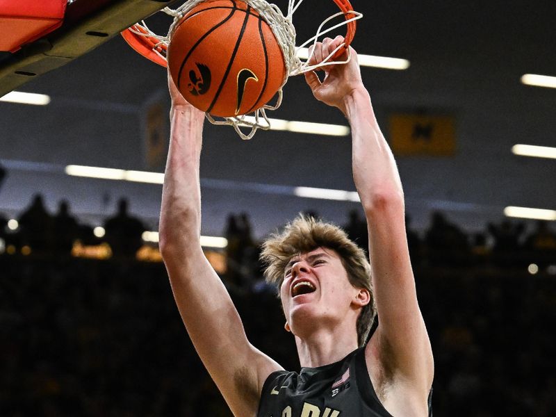 Feb 14, 2026; Iowa City, Iowa, USA; Purdue Boilermakers center Daniel Jacobsen (12) completes a slam dunk against the Iowa Hawkeyes during the first half at Carver-Hawkeye Arena. Mandatory Credit: Jeffrey Becker-Imagn Images