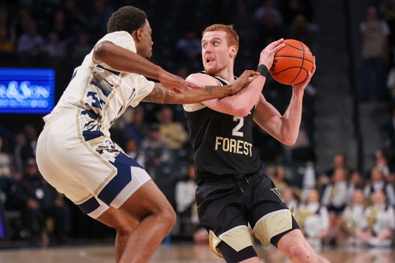 Feb 6, 2024; Atlanta, Georgia, USA; Wake Forest Demon Deacons guard Cameron Hildreth (2) is defended by Georgia Tech Yellow Jackets forward Tyzhaun Claude (12) in the first half at McCamish Pavilion. Mandatory Credit: Brett Davis-USA TODAY Sports