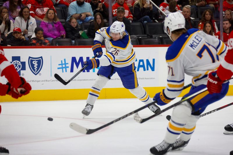 Nov 2, 2024; Detroit, Michigan, USA; Buffalo Sabres defenseman Rasmus Dahlin (26) shoots the puck during the first period of the game against the Detroit Red Wings at Little Caesars Arena. Mandatory Credit: Brian Bradshaw Sevald-Imagn Images