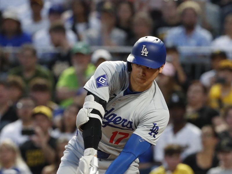 Jun 4, 2024; Pittsburgh, Pennsylvania, USA;  Los Angeles Dodgers designated hitter Shohei Ohtani (17) hits a single against the Pittsburgh Pirates during the eighth inning at PNC Park. The Pirates shutout the Dodgers 1-0. Mandatory Credit: Charles LeClaire-USA TODAY Sports