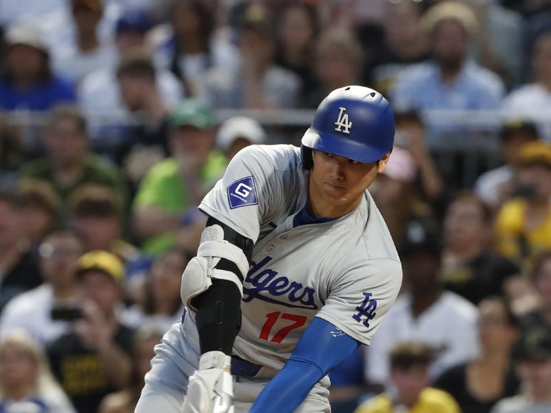 Jun 4, 2024; Pittsburgh, Pennsylvania, USA;  Los Angeles Dodgers designated hitter Shohei Ohtani (17) hits a single against the Pittsburgh Pirates during the eighth inning at PNC Park. The Pirates shutout the Dodgers 1-0. Mandatory Credit: Charles LeClaire-USA TODAY Sports