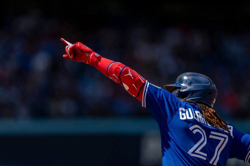 Aug 13, 2023; Toronto, Ontario, CAN; Toronto Blue Jays first baseman Vladimir Guerrero Jr. (27) celebrates after hitting a single during the fourth inning against the Chicago Cubs at Rogers Centre. Mandatory Credit: Kevin Sousa-USA TODAY Sports