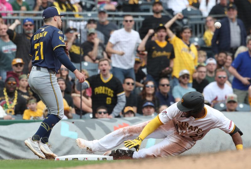 May 25, 2025; Pittsburgh, Pennsylvania, USA;  Pittsburgh Pirates right fielder Alexander Canario (29) slides safely into third base with a triple as Milwaukee Brewers third baseman Caleb Durbin (21) looks for a throw during the sixth inning at PNC Park. Mandatory Credit: Charles LeClaire-Imagn Images