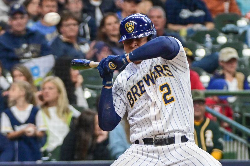 Jun 11, 2023; Milwaukee, Wisconsin, USA; Milwaukee Brewers third baseman Luis Ur as (2) avoids getting hit by a pitch in the eighth inning against the Oakland Athletes at American Family Field. Mandatory Credit: Benny Sieu-USA TODAY Sports