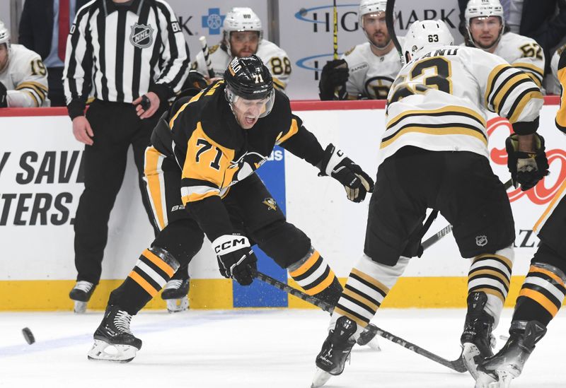 Apr 13, 2024; Pittsburgh, Pennsylvania, USA; Pittsburgh Penguins center Evgeni Malkin (71) reacts after Boston Bruins left wing Brad Marchand (63) moves the puck during the first period at PPG Paints Arena. Mandatory Credit: Philip G. Pavely-USA TODAY Sports