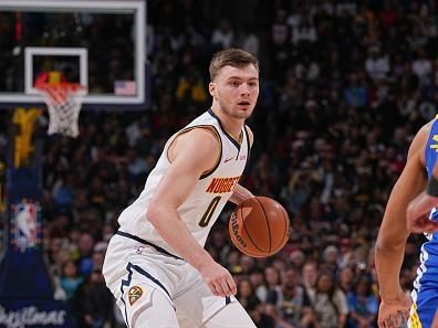 DENVER, CO - DECEMBER 25: Christian Braun #0 of the Denver Nuggets looks on during the game against the Golden State Warriors on December 25, 2023 at the Ball Arena in Denver, Colorado. NOTE TO USER: User expressly acknowledges and agrees that, by downloading and/or using this Photograph, user is consenting to the terms and conditions of the Getty Images License Agreement. Mandatory Copyright Notice: Copyright 2023 NBAE (Photo by Bart Young/NBAE via Getty Images)