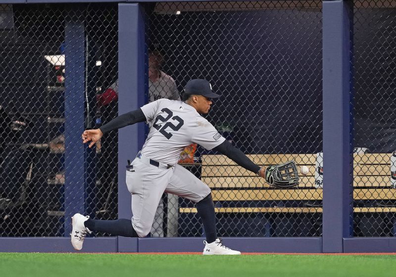 Apr 17, 2024; Toronto, Ontario, CAN; New York Yankees right fielder Juan Soto (22) is unable to handle a fly ball against the Toronto Blue Jays during the sixth inning at Rogers Centre. Mandatory Credit: Nick Turchiaro-USA TODAY Sports