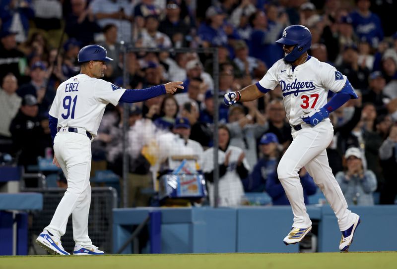 Apr 28, 2025; Los Angeles, California, USA; Los Angeles Dodgers outfielder Teoscar Hernandez (37) celebrates with third base coach Dino Ebel (91) after hitting a two-run home run during the third inning against the Miami Marlins at Dodger Stadium. Mandatory Credit: Jason Parkhurst-Imagn Images