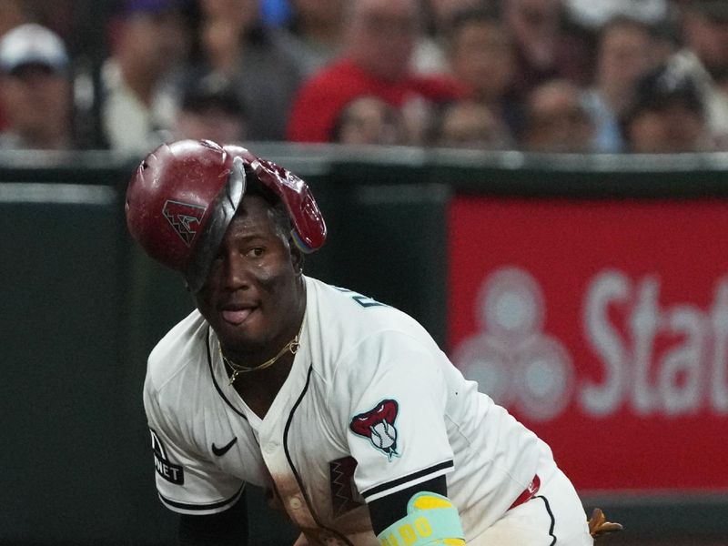 Apr 27, 2025; Phoenix, Arizona, USA; Arizona Diamondbacks shortstop Geraldo Perdomo (2) reacts after advancing to third against the Atlanta Braves in the seventh inning at Chase Field. Mandatory Credit: Rick Scuteri-Imagn Images