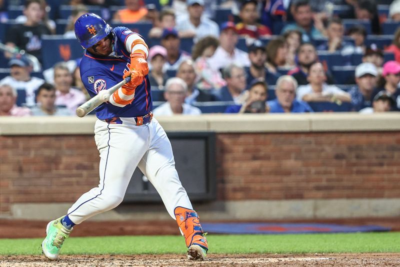 Jun 26, 2024; New York City, New York, USA;  New York Mets catcher Francisco Alvarez (4) hits a two run home run in the third inning against the New York Yankees at Citi Field. Mandatory Credit: Wendell Cruz-USA TODAY Sports