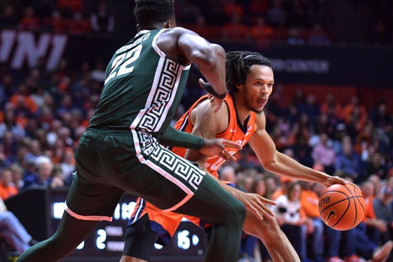 Jan 11, 2024; Champaign, Illinois, USA;  Illinois Fighting Illini forward Ty Rodgers (20) drives the ball against Michigan State Spartans center Mady Sissoko (22) during the first half at State Farm Center. Mandatory Credit: Ron Johnson-USA TODAY Sports