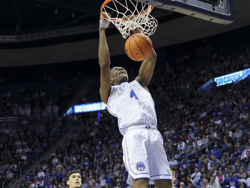 Feb 13, 2024; Provo, Utah, USA; Brigham Young Cougars forward Atiki Ally Atiki (4) dunks the ball against the Central Florida Knights during the second half at Marriott Center. Mandatory Credit: Rob Gray-USA TODAY Sports