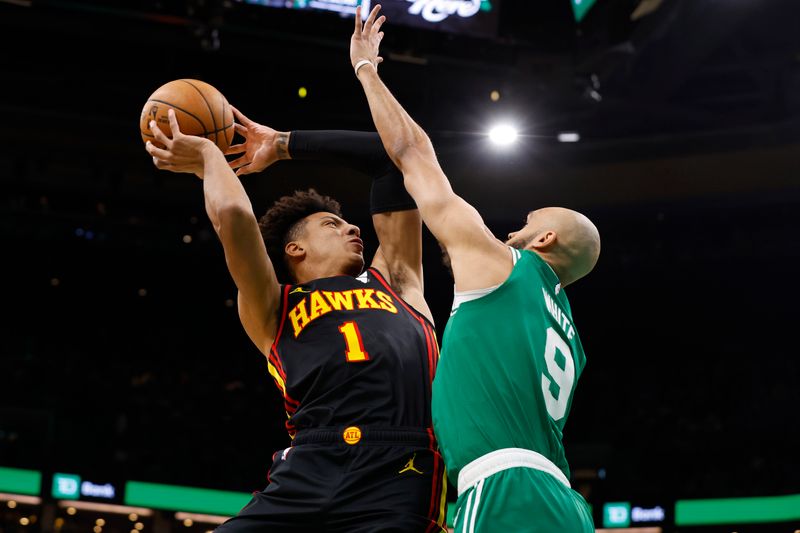 BOSTON, MA - FEBRUARY 7: Jalen Johnson #1 of the Atlanta Hawks goes up for a shot against Derrick White #9 of the Boston Celtics during the first quarter at TD Garden on February 7, 2024 in Boston, Massachusetts. NOTE TO USER: User expressly acknowledges and agrees that, by downloading and/or using this Photograph, user is consenting to the terms and conditions of the Getty Images License Agreement. (Photo By Winslow Townson/Getty Images)