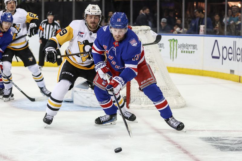 Feb 28, 2026; New York, New York, USA;  Pittsburgh Penguins defenseman Samuel Girard (49) and New York Rangers left wing Alexis Lafrenière (13) chase after the puck in the second period at Madison Square Garden. Mandatory Credit: Wendell Cruz-Imagn Images
