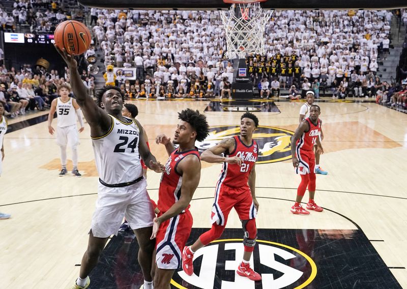 Mar 4, 2023; Columbia, Missouri, USA; Missouri Tigers guard Kobe Brown (24) shoots as Mississippi Rebels forward Jaemyn Brakefield (4) defends during the second half at Mizzou Arena. Mandatory Credit: Denny Medley-USA TODAY Sports