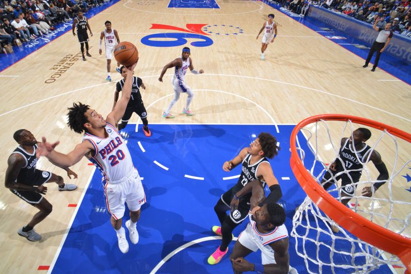 PHILADELPHIA, PA - OCTOBER 16: Jared McCain #20 of the Philadelphia 76ers rebounds the ball during the game against the Brooklyn Nets during a NBA preseason game on October 16, 2024 at the Wells Fargo Center in Philadelphia, Pennsylvania NOTE TO USER: User expressly acknowledges and agrees that, by downloading and/or using this Photograph, user is consenting to the terms and conditions of the Getty Images License Agreement. Mandatory Copyright Notice: Copyright 2024 NBAE (Photo by Jesse D. Garrabrant/NBAE via Getty Images)