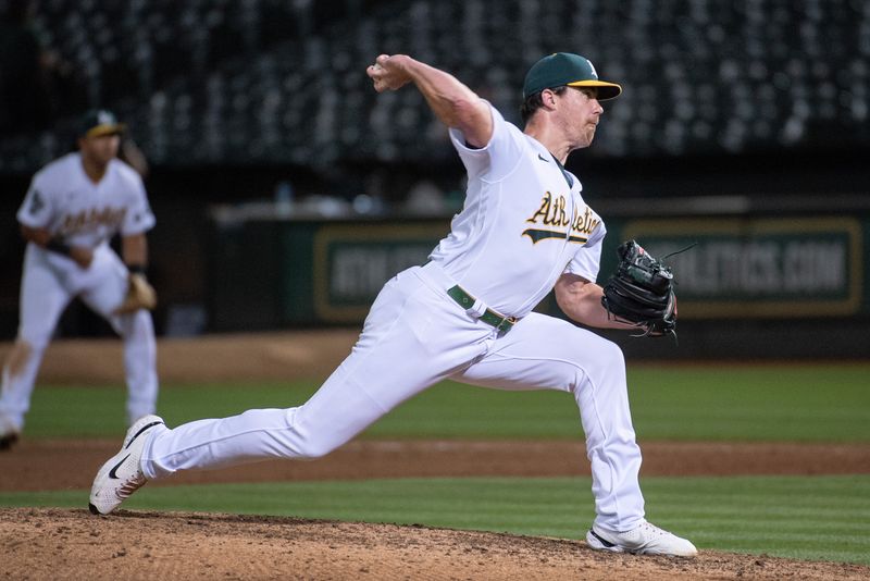 Aug 22, 2023; Oakland, California, USA; Oakland Athletics relief pitcher Trevor May (65) throws a pitch during the ninth inning against the Kansas City Royals at Oakland-Alameda County Coliseum. Mandatory Credit: Ed Szczepanski-USA TODAY Sports