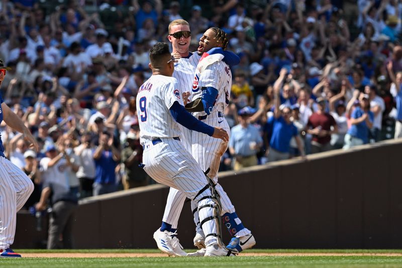 May 18, 2024; Chicago, Illinois, USA; Chicago Cubs outfielder Pete Crow-Armstrong (52) and catcher Miguel Amaya (9) hug third base Christopher Morel (5) after Morel hit a game winning RBI single against the Pittsburgh Pirates  at Wrigley Field. Mandatory Credit: Matt Marton-USA TODAY Sports