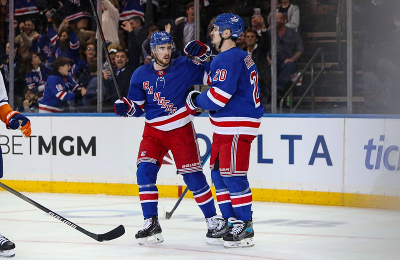 Sep 24, 2024; New York, New York, USA; New York Rangers right wing Reilly Smith (91) and left wing Chris Kreider (20) celebrate Kreider’s goal against the New York Islanders during the third period at Madison Square Garden. Mandatory Credit: Danny Wild-Imagn Images