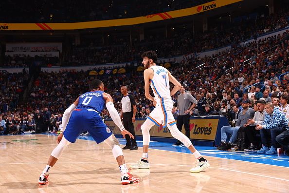 OKLAHOMA CITY, OK - DECEMBER 21: Chet Holmgren #7 of the Oklahoma City Thunder handles the ball against Russell Westbrook #0 of the LA Clippers during the game on December 21, 2023 at Paycom Arena in Oklahoma City, Oklahoma. NOTE TO USER: User expressly acknowledges and agrees that, by downloading and or using this photograph, User is consenting to the terms and conditions of the Getty Images License Agreement. Mandatory Copyright Notice: Copyright 2023 NBAE (Photo by Zach Beeker/NBAE via Getty Images)