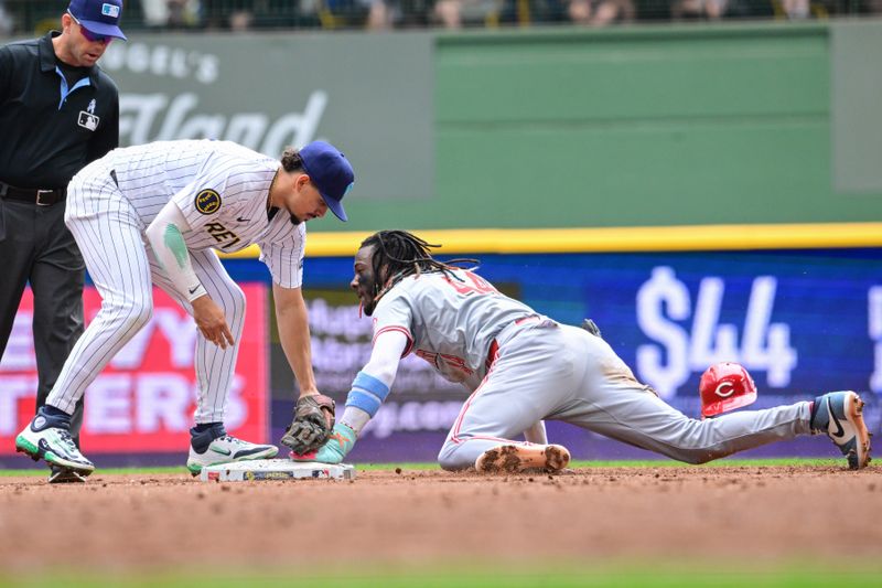 Jun 16, 2024; Milwaukee, Wisconsin, USA;  Cincinnati Reds shortstop Elly De La Cruz (44) steals second base before tag by Milwaukee Brewers shortstop Willy Adames (27) in the third inning at American Family Field. Mandatory Credit: Benny Sieu-USA TODAY Sports