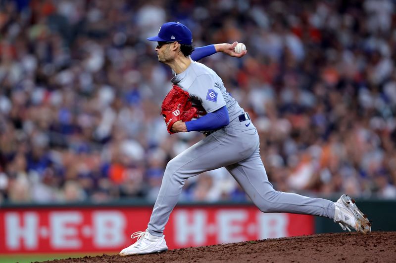 Jul 28, 2024; Houston, Texas, USA; Los Angeles Dodgers relief pitcher Joe Kelly (99) delivers a pitch against the Houston Astros during the eighth inning at Minute Maid Park. Mandatory Credit: Erik Williams-USA TODAY Sports